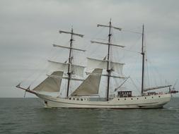 small white Sailing Vessel on Sea