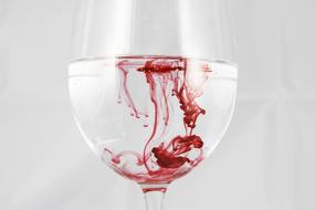 red liquid in water in a glass