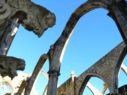 Beautiful Convento Do Carmo with arches in sunlight, in Lisbon, Portugal, under the blue sky