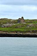 view from the water of the ruins on an island in ireland