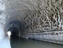Landscape of the river cave tunnel, with light in the end