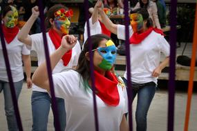 People in colorful clothes and masks, together