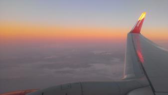 airplane wing in the sky at dusk