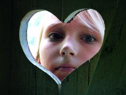 heart-shaped hole on a wooden toilet door