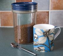 can of coffee and cup