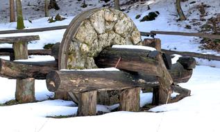 Close-up of the stone and wooden construction among the beautiful snow, in Kalisz Pomorski, Poland, in the winter