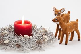 toy deer and red christmas candle