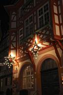 half timbered house facade decorated for Christmas at night