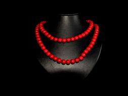 red beads on black bust