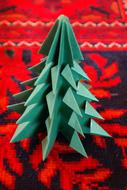 green origami in the form of a christmas tree