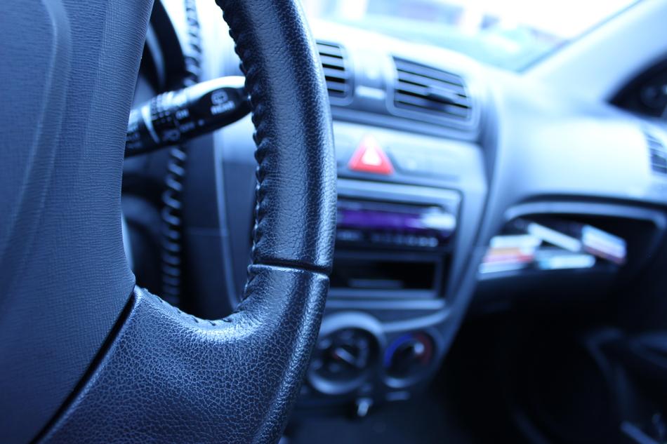 Close-up of the steering wheel and dashboard in interior of the car