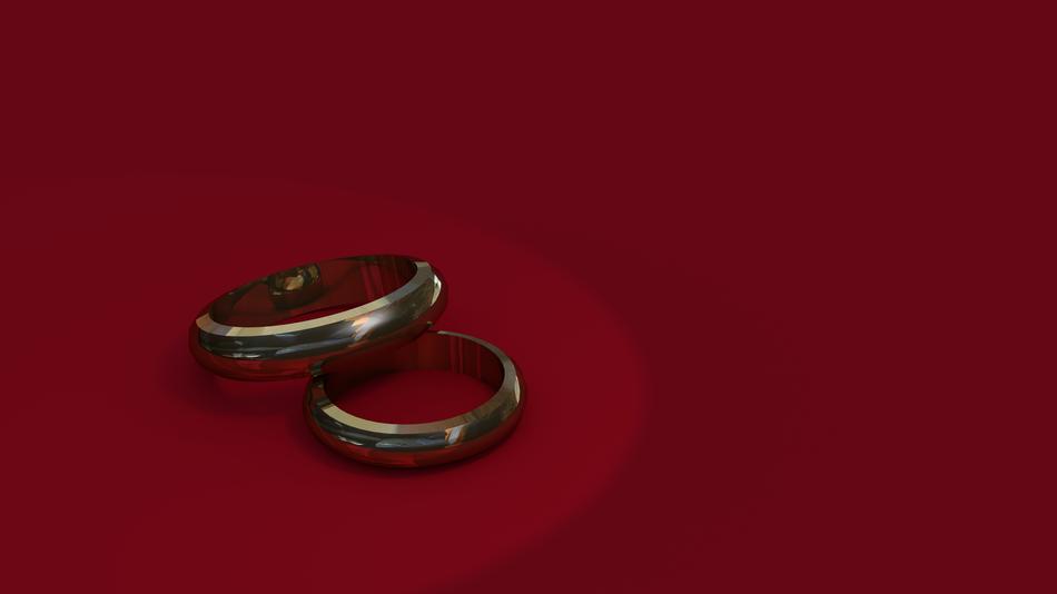 wedding rings on a burgundy background