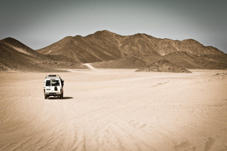 Van in the beautiful desert near the mountains