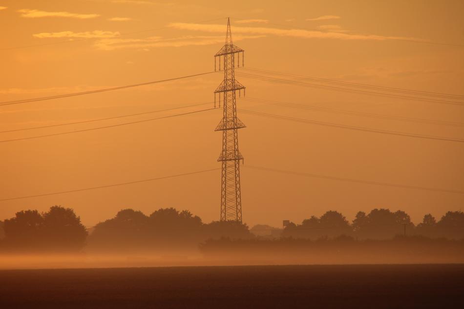 Strommast in the orange misty twilight