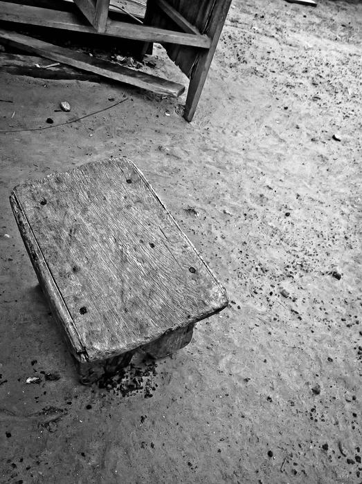 old wooden stool in black and white background