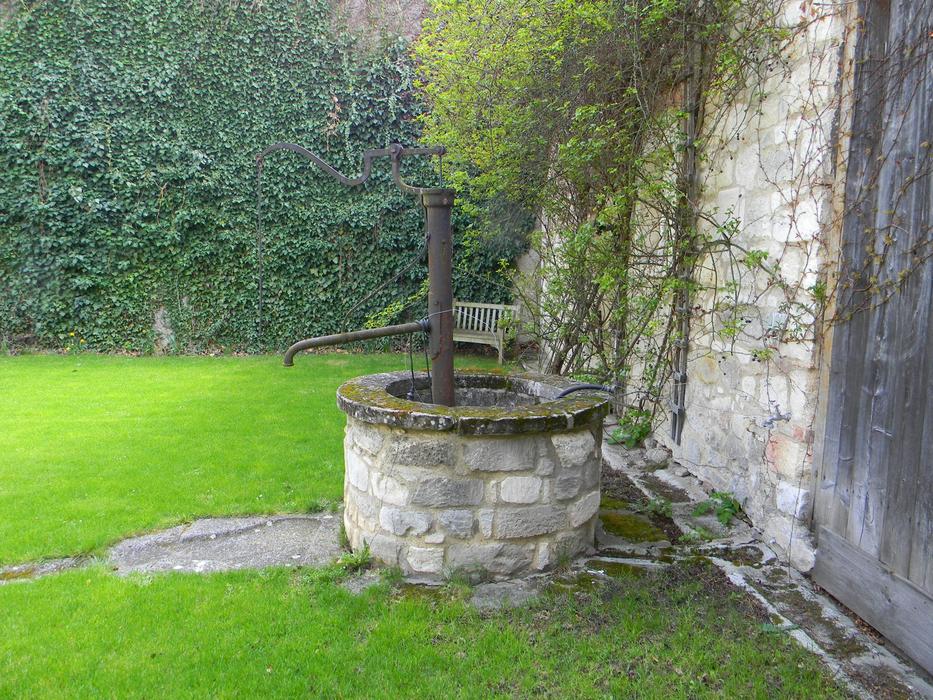 stone fence near the fountain in the yard