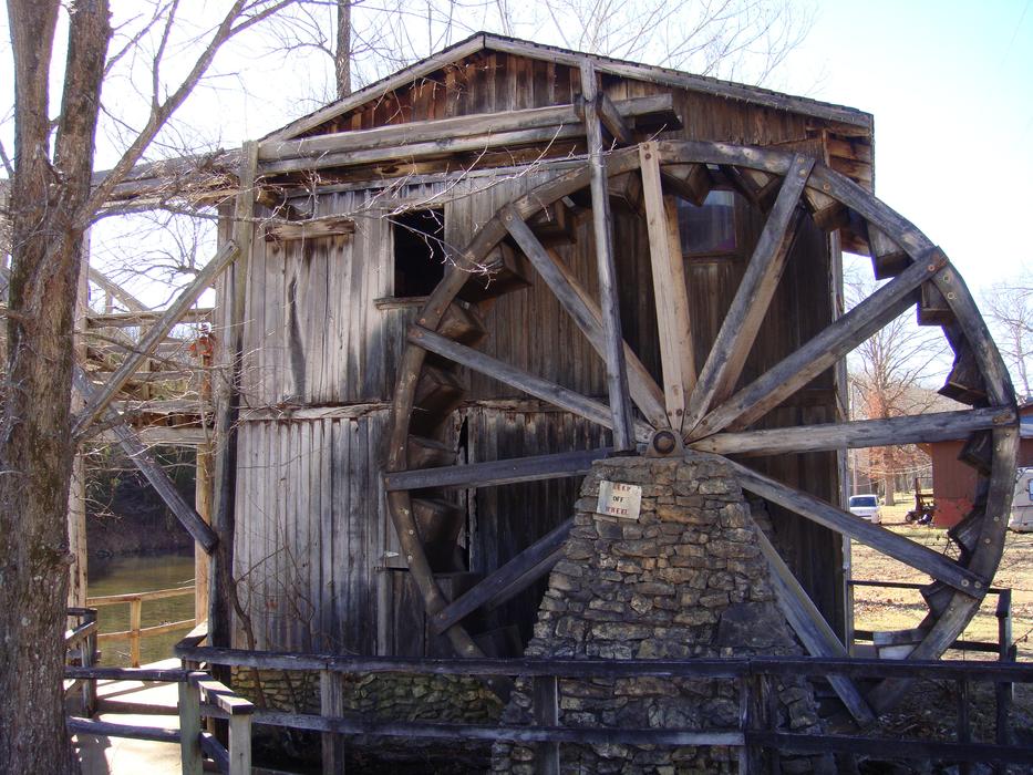 Wooden water wheel near the beautiful river on the mountainside