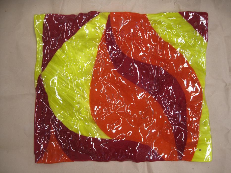 Close-up of the colorful glass shape with patterns and wrinkles