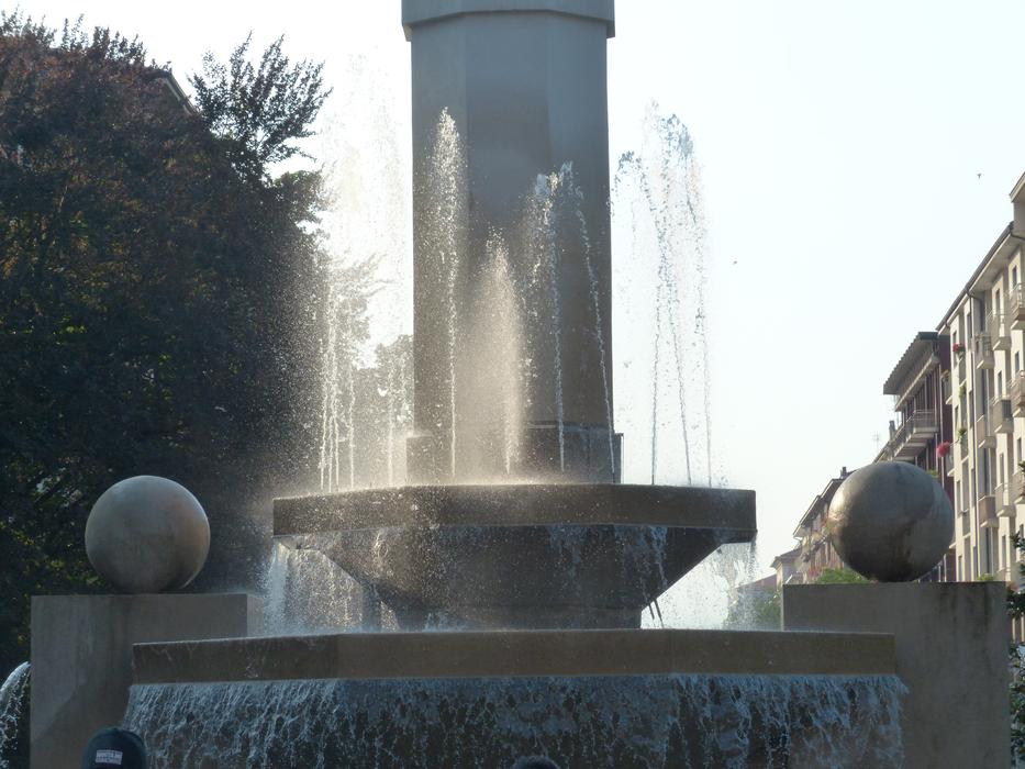 fountain with a stone stand in the city