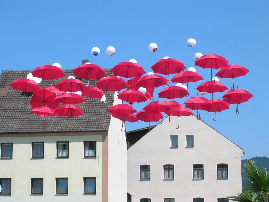 pink umbrellas in the air as street design