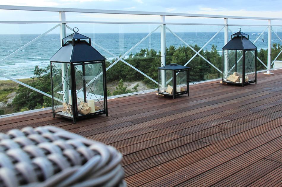 wicker chair next to the lanterns on the terrace
