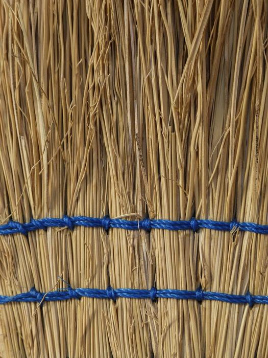 Close-up of the straw in brooms with blue rubber