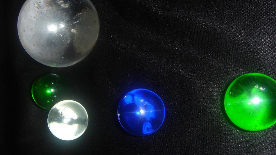 white, blue and green glass balls