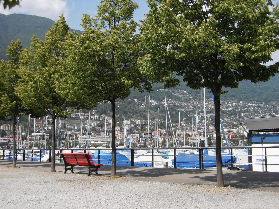 Beautiful landscape of the port of Ticino, Switzerland, with benches and trees