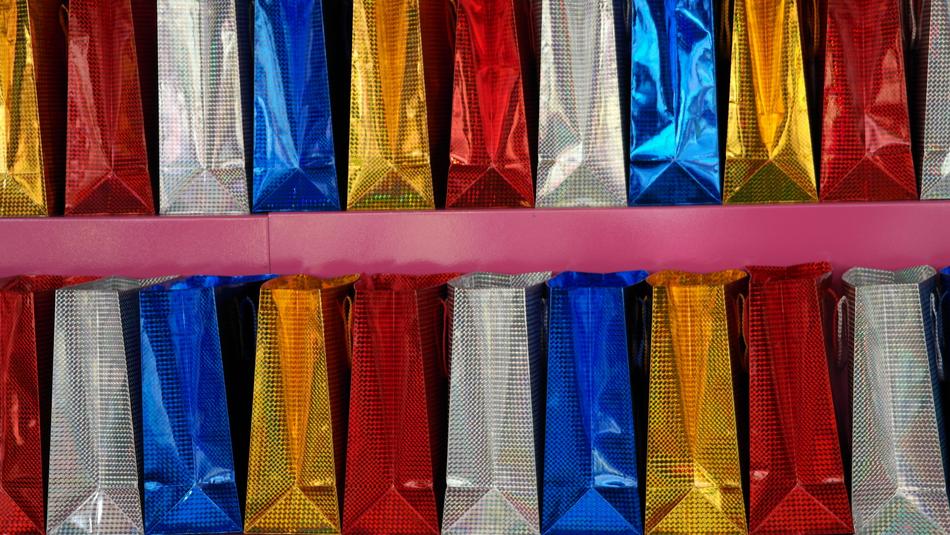 Close-up of the colorful, shiny bags in rows