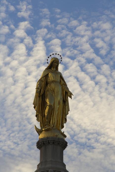 evening clouds over the statue of mary