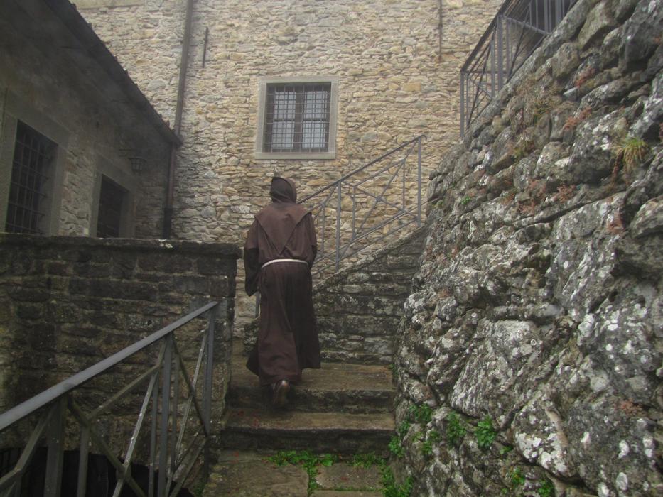 Monk on the stairs of the beautiful monastery, with windows