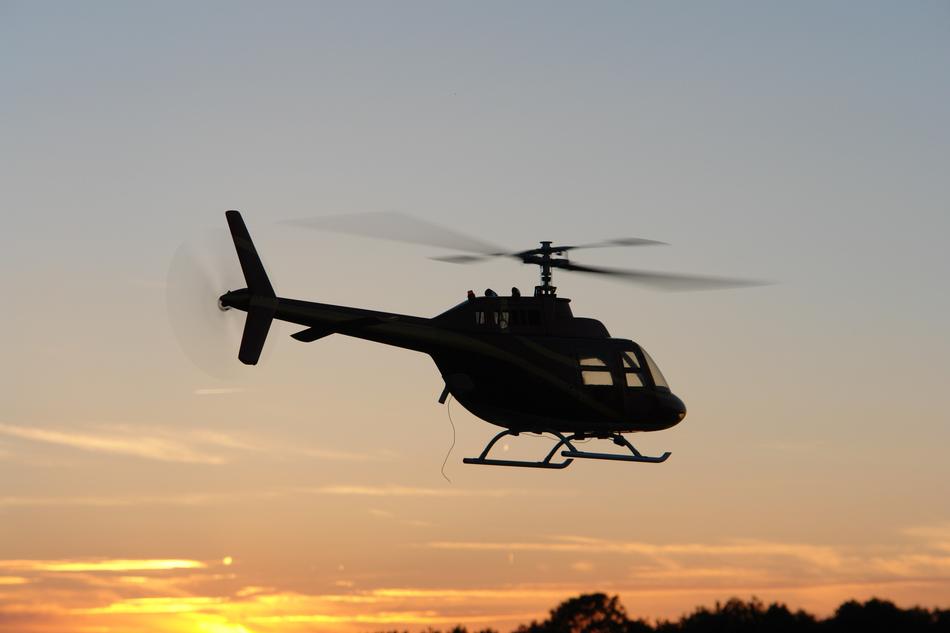 helicopter in the sky during sunset