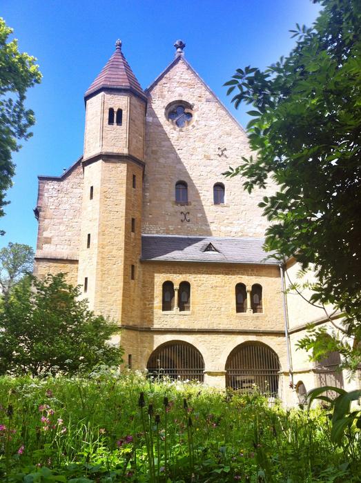 Beautiful landscape with the Imperial Palace in Goslar, Germany, among the plants, in sunlight, under the blue sky