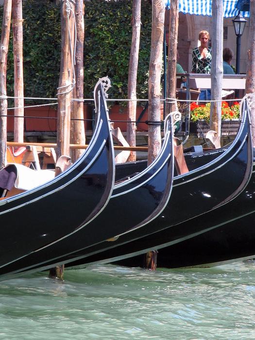 gondolas in a row on a canal in venice close up