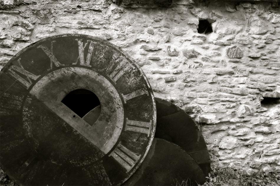 vintage clockface at stone wall