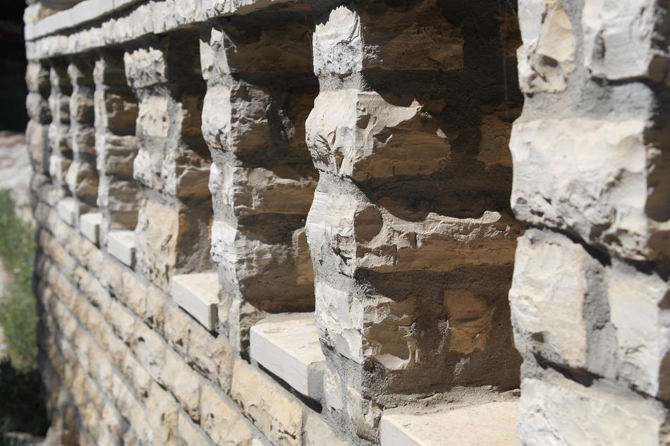 Stone columns in the wall, in sunlight