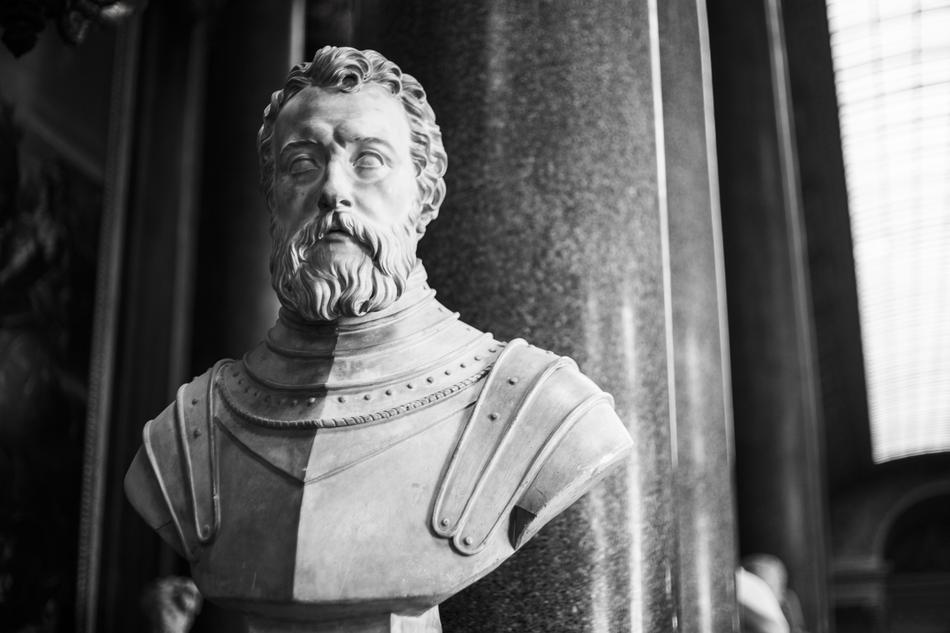 Black and white statue of the bearded man in Versailles, France