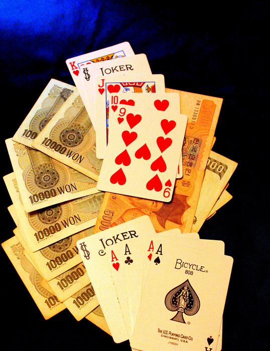 Close-up of the colorful 'Bicycle cards' and banknotes
