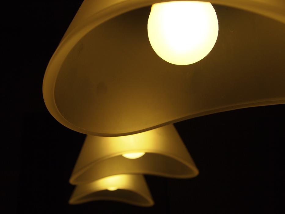 Close-up of the light lamps with penumbra, among the darkness