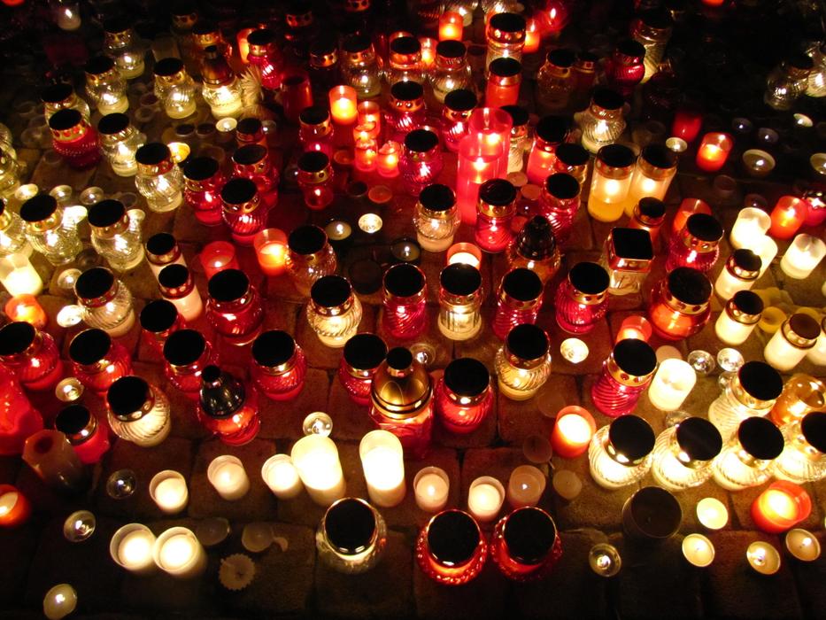 Close-up of the colorful, glowing candles on the graves at the Day of the Dead