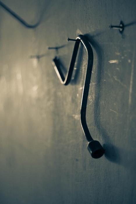 metal key hanging on the wall