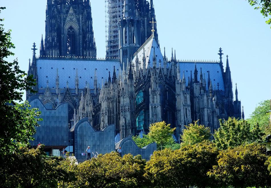 building in a gothic stele behind green trees