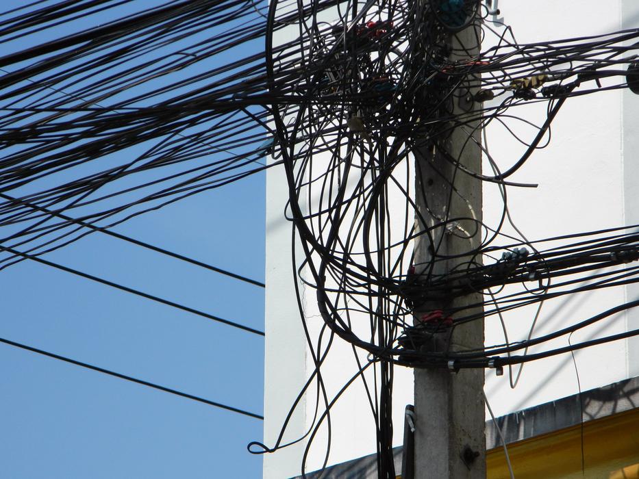 black web of wires on a lamp post