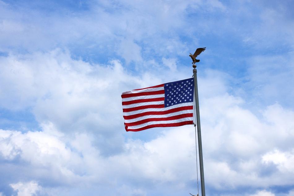 eagle on the flagpole of the american flag