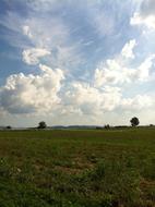 landscape of rural field and cloudy sky