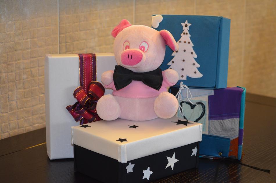 plush pig and gift boxes on the table