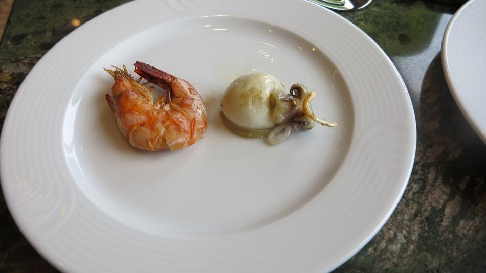 squid and shrimp on a platter in a restaurant