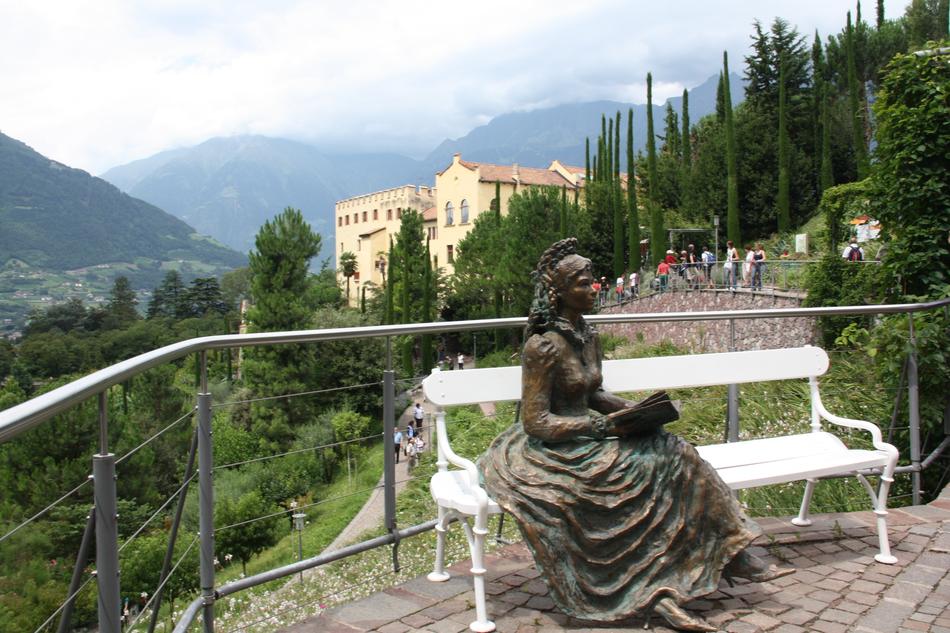 Bronze statue of Empress Sissi in view of park and Trauttmansdorff Castle, Italy, Merano