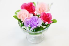 artificial roses in a glass