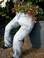 decoration in the garden in the form of jeans with flowers